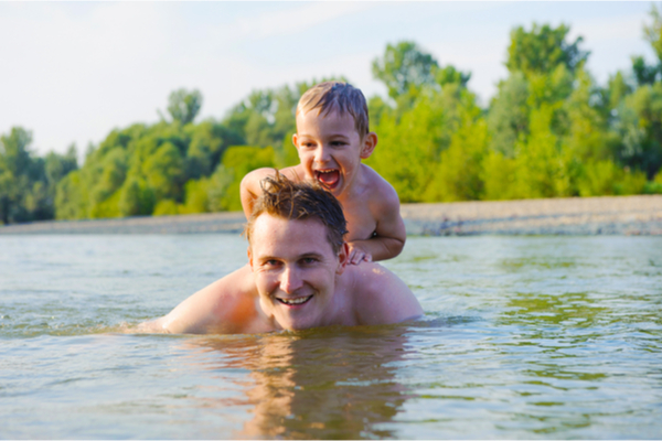 a man and his son in the water