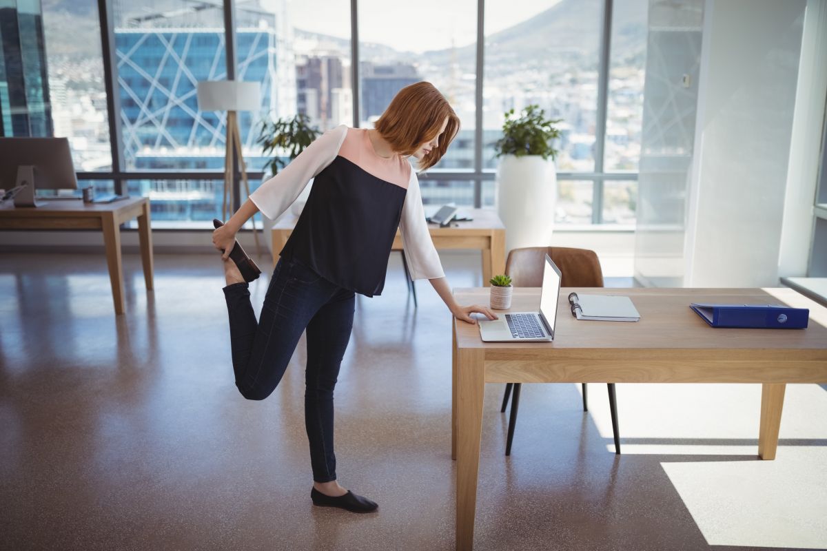 Woman stretching at desk
