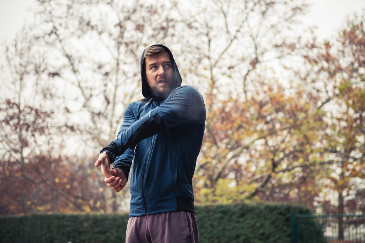 male runner stretching