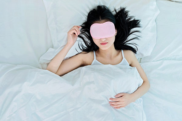 Woman sleeping with an eye mask Woman sleeping with an eye mask