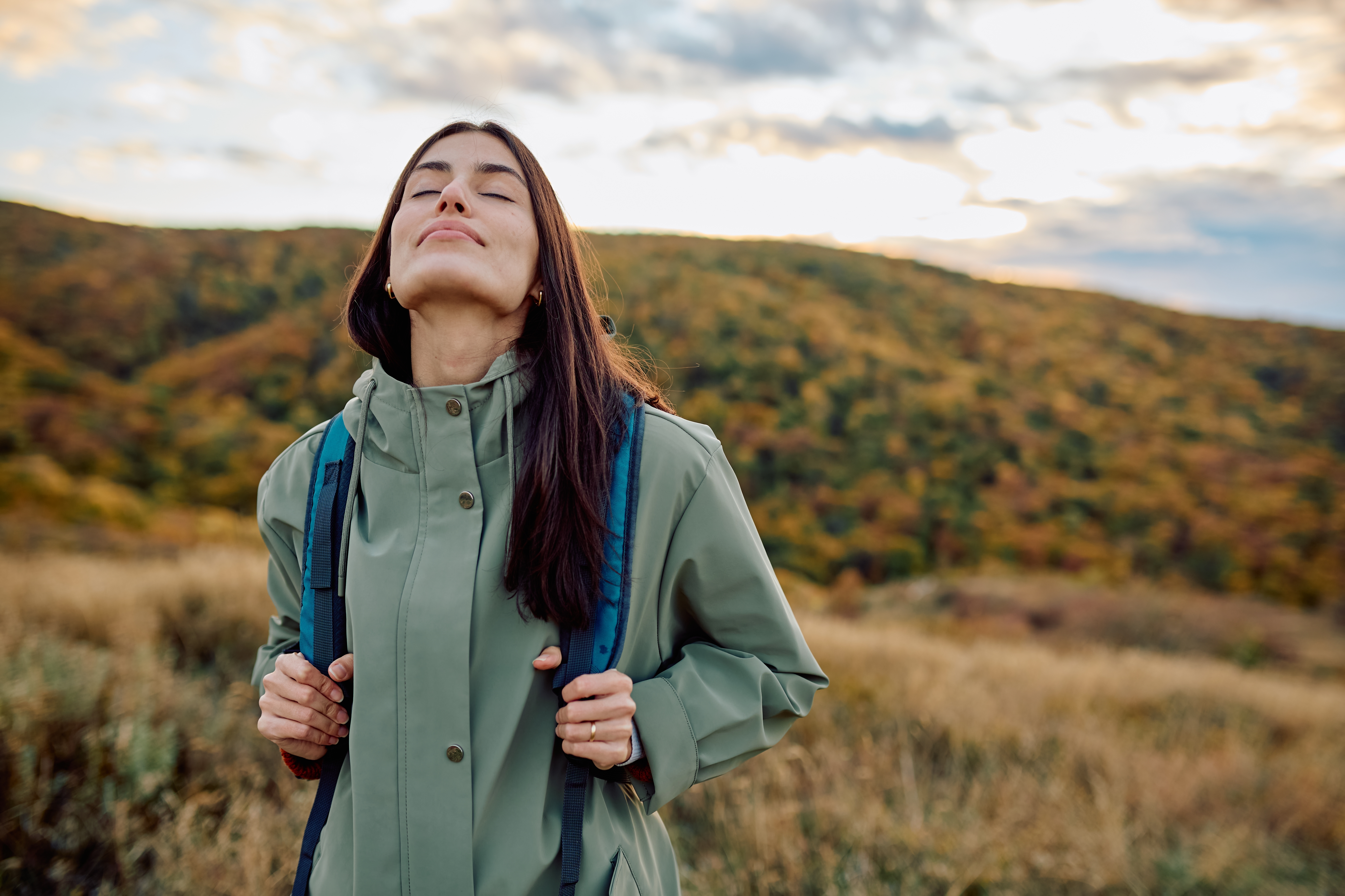 Happy woman hiking practising mindfulness