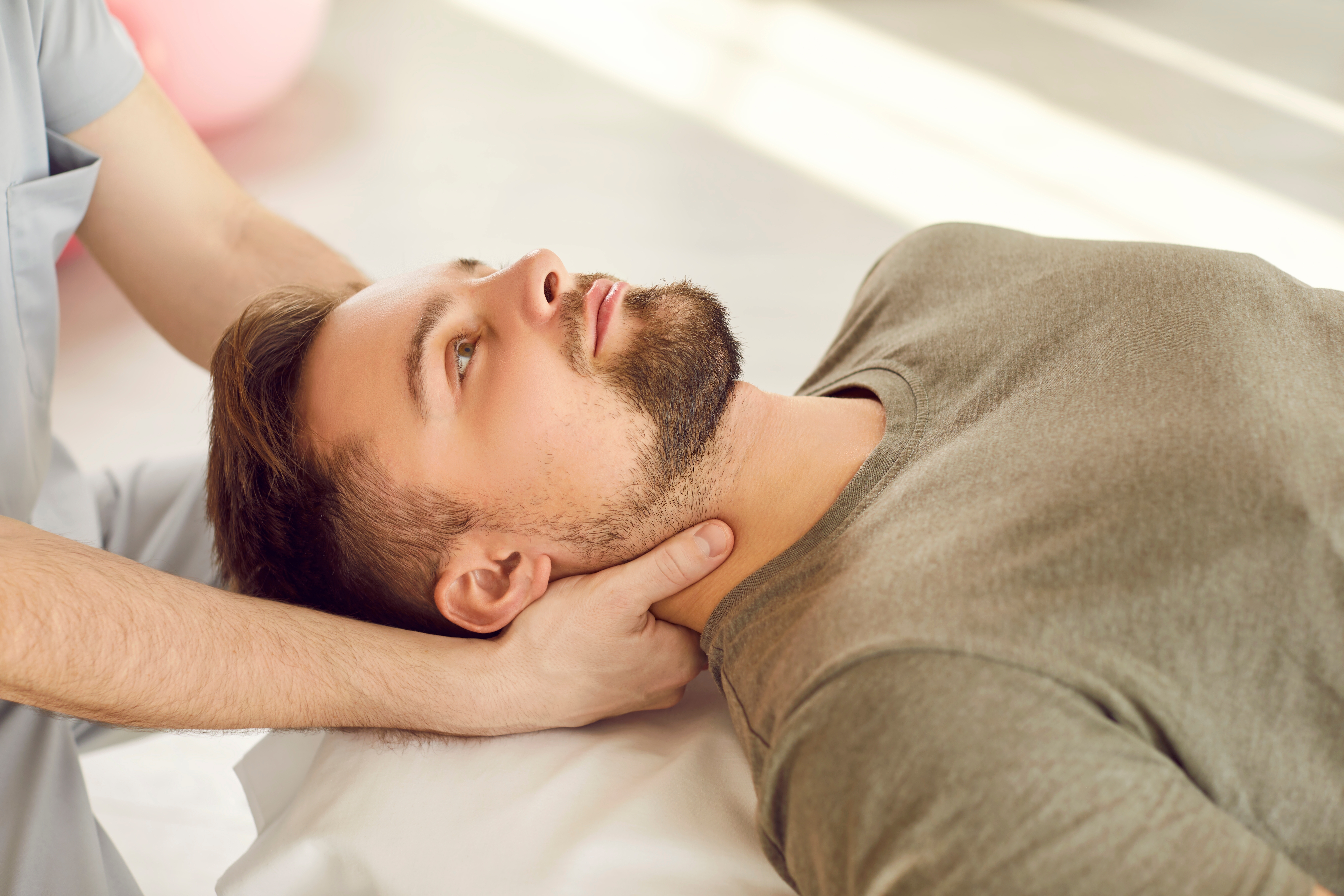 Man finding relief from migraine symptoms with myofascial release technique