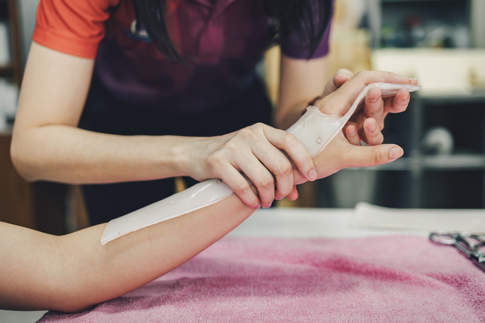 Occupational therapist helping client use arm