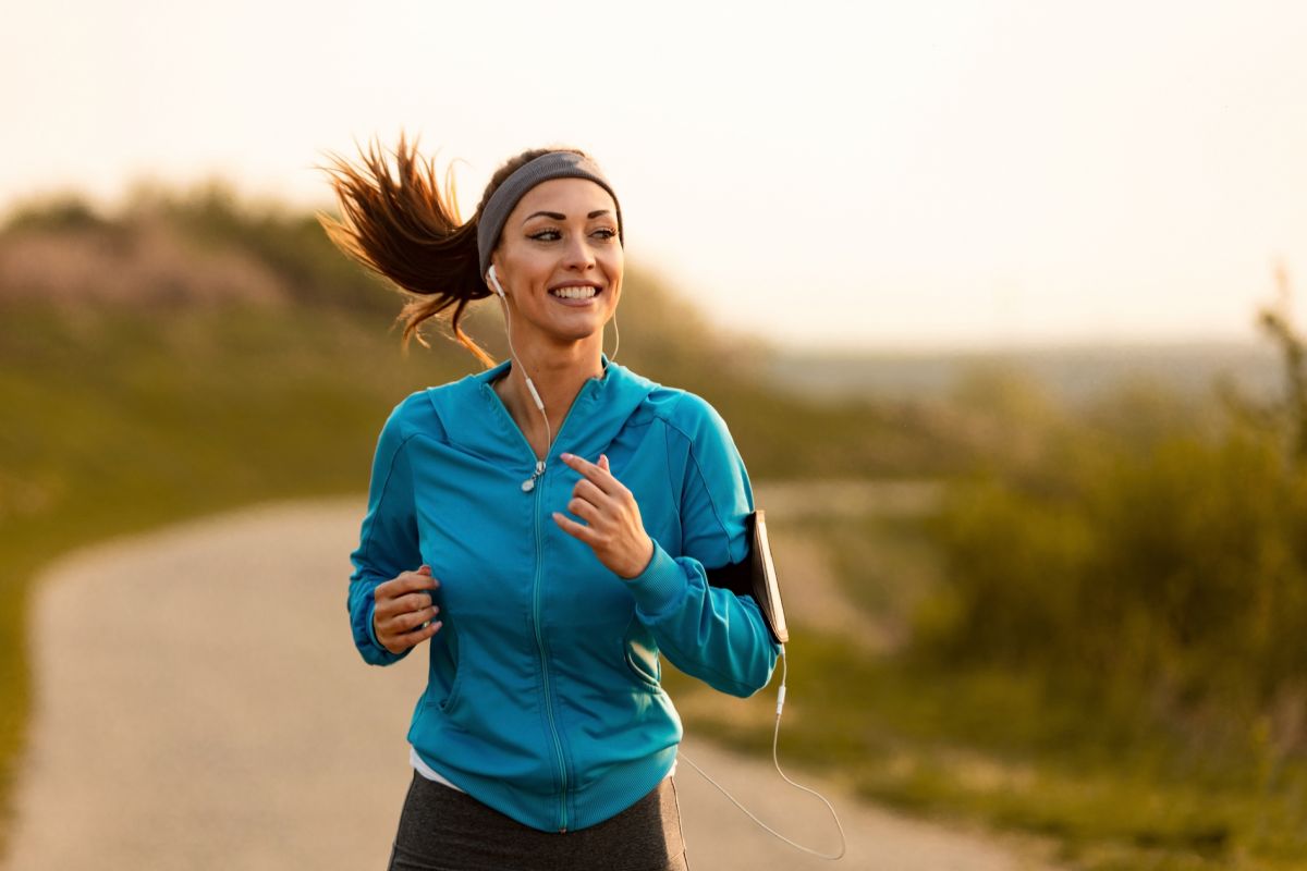 Woman running outdoors for self-care