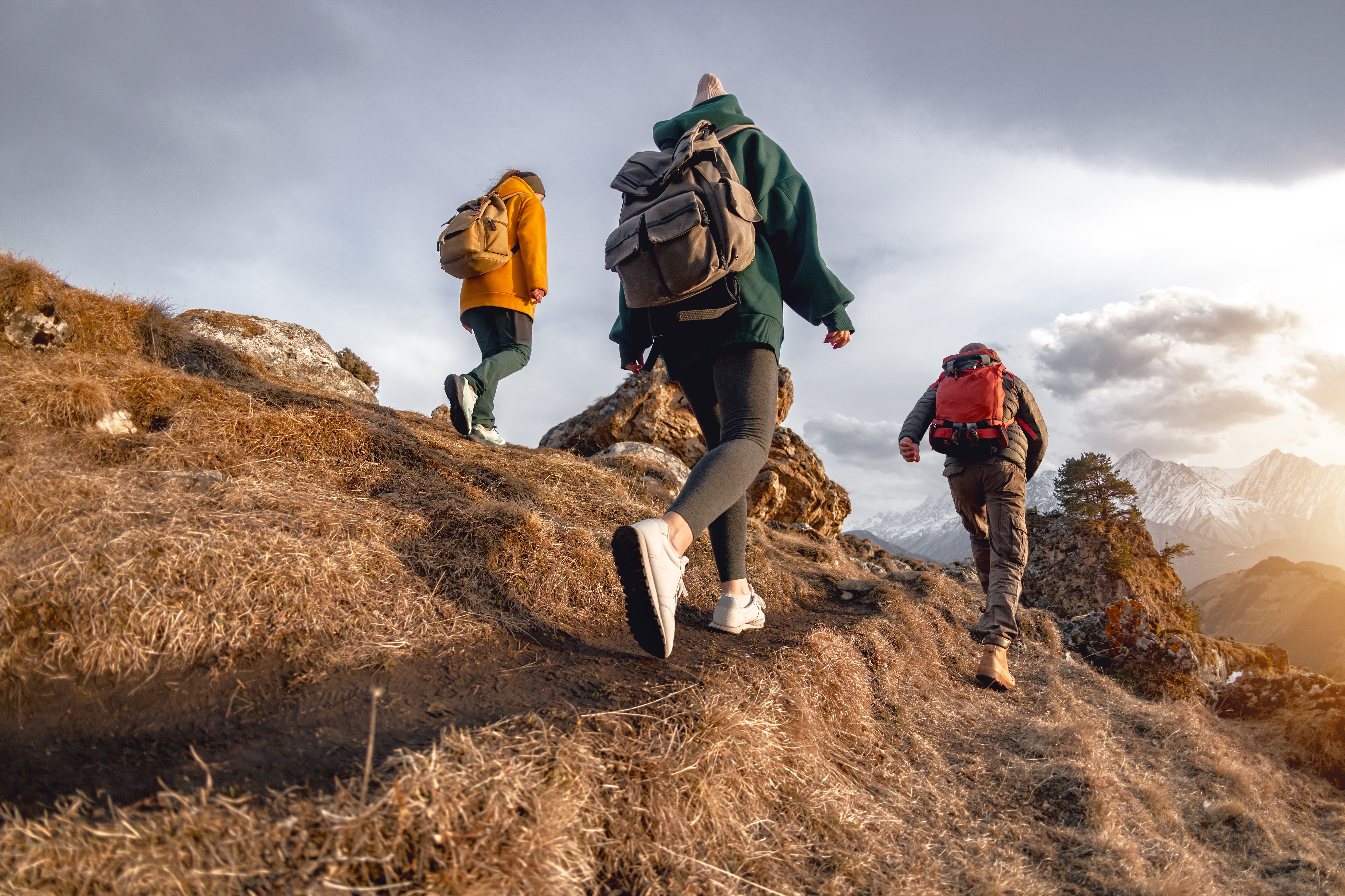 3 people hiking up a mountain