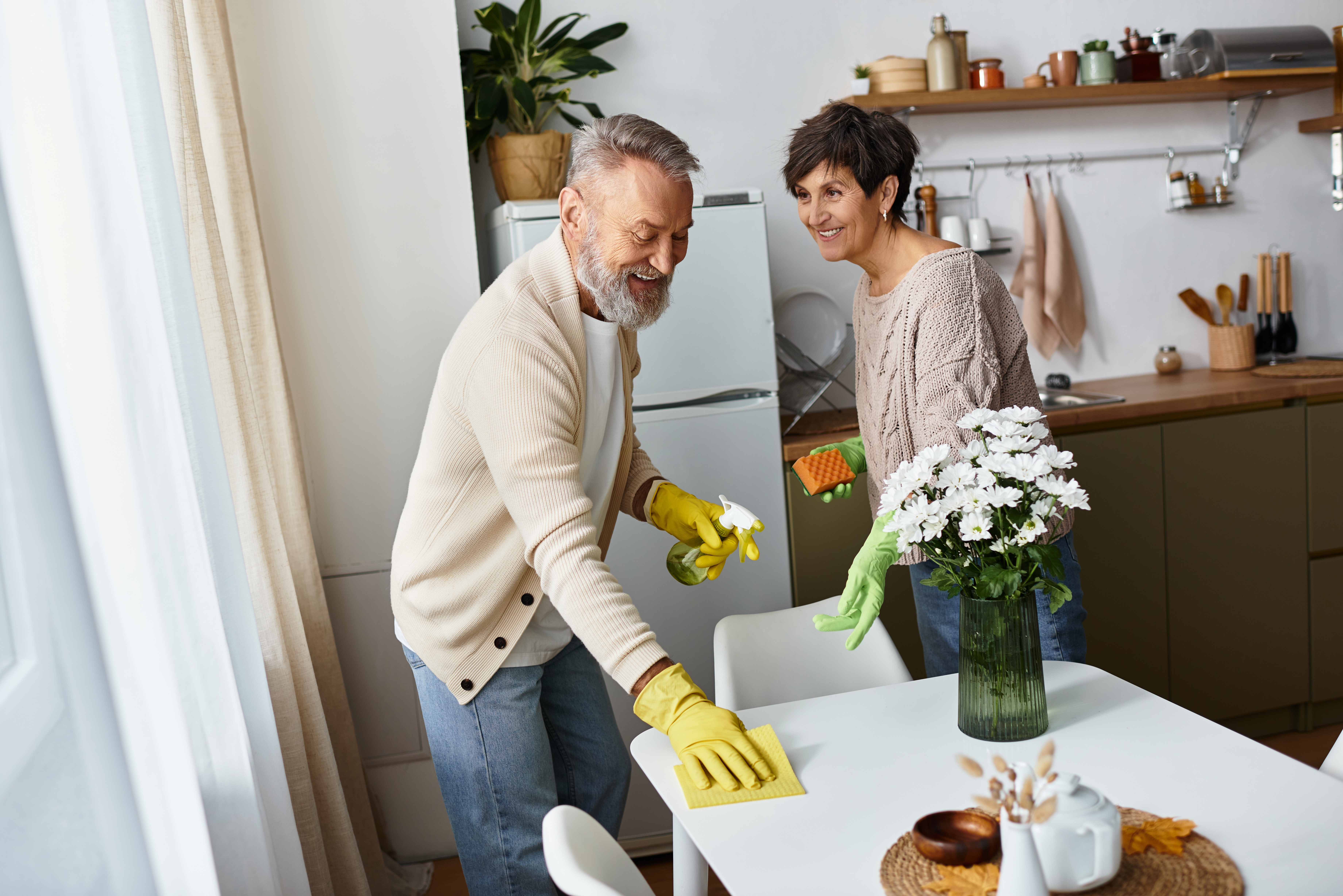 Senior couple staying active while spring cleaning