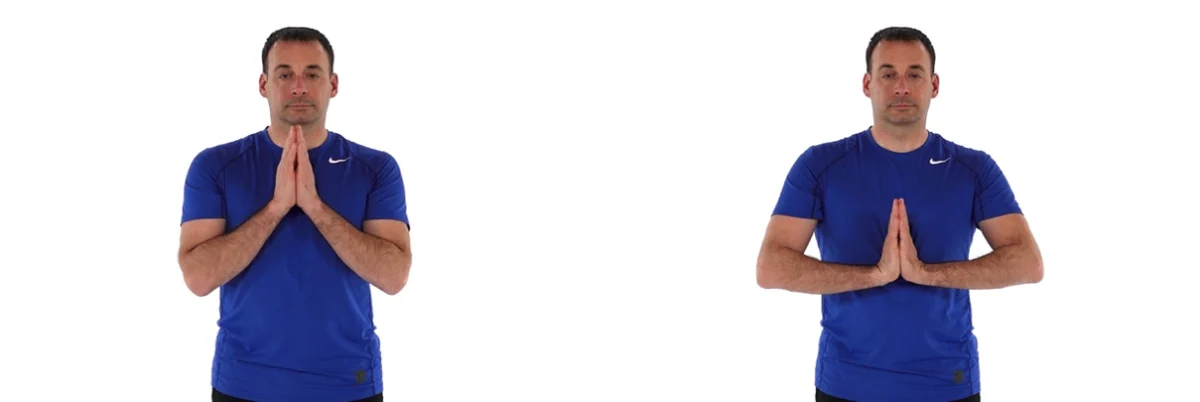 Man performing prayer stretch for carpal tunnel syndrome relief