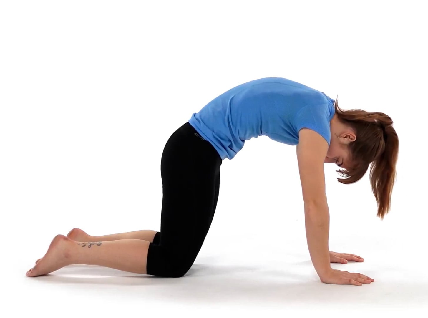 women relieving low back pain with cat-camel stretch
