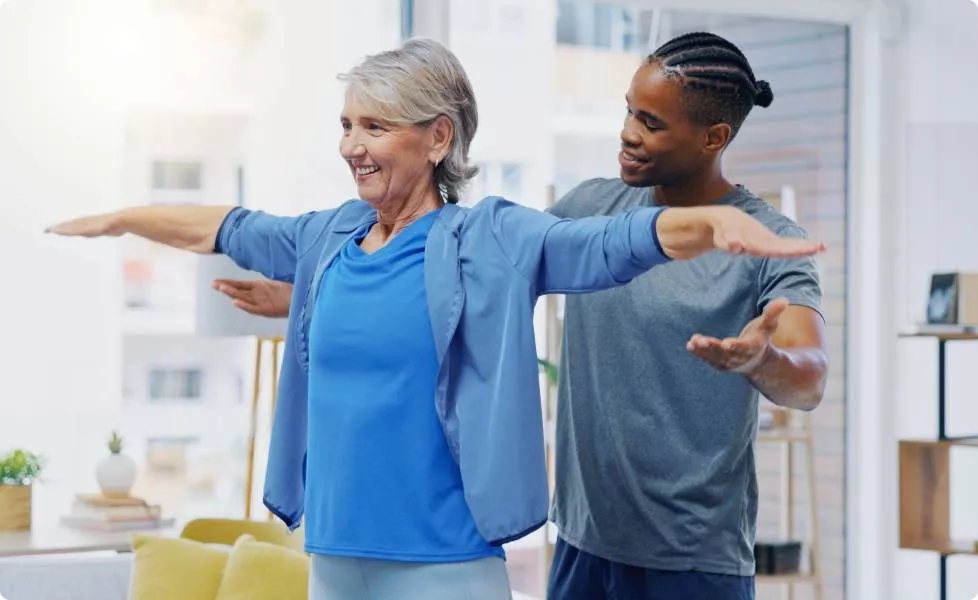 A black man supporting an elderly woman