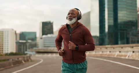 Senior man running outdoors doing speed training