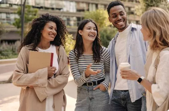 A diverse group of students laughing outside school