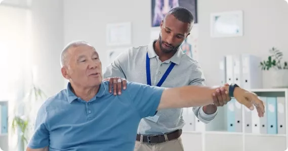 A black lifemark therapist helping an elderly man