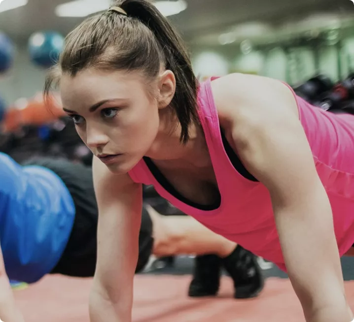 A man and woman in plank formation at a fitness class