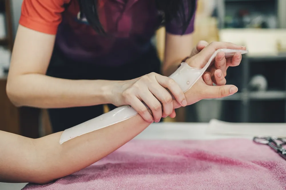 Occupational therapist helping client use arm