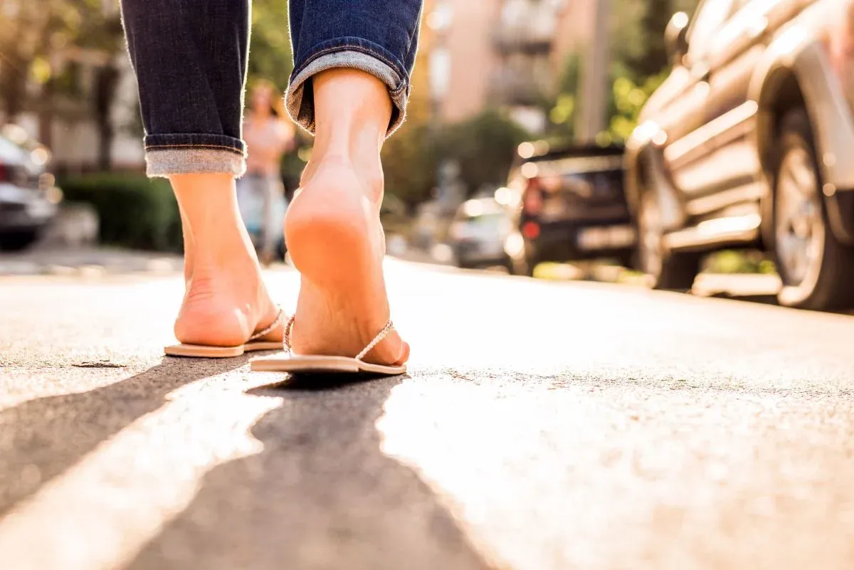 Heel of foot while walking on a sidewalk