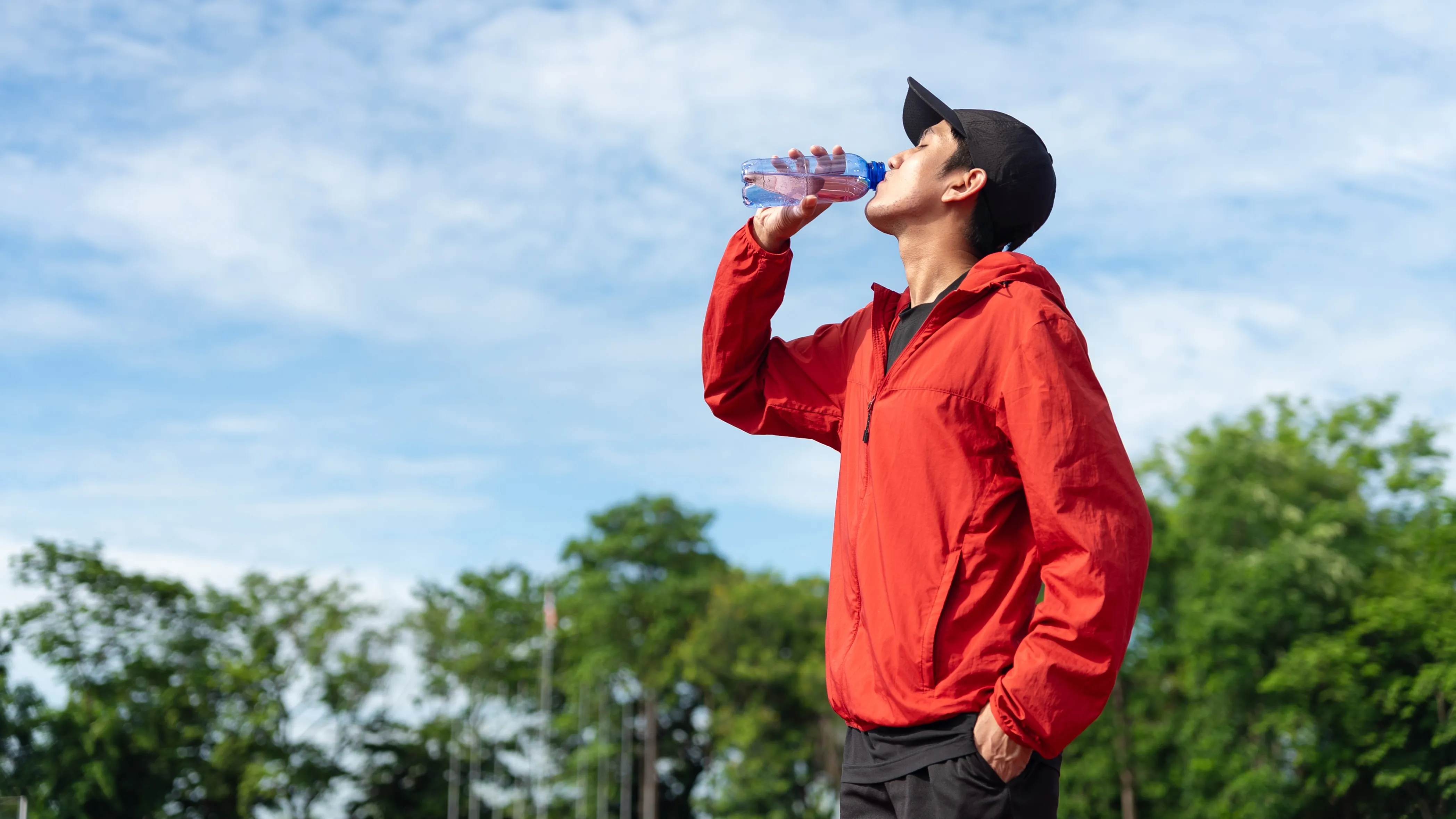Man drinking water to avoid dehydration